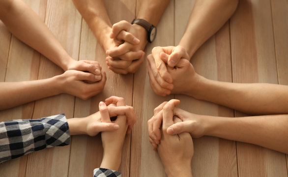 Hands in Prayer on Table